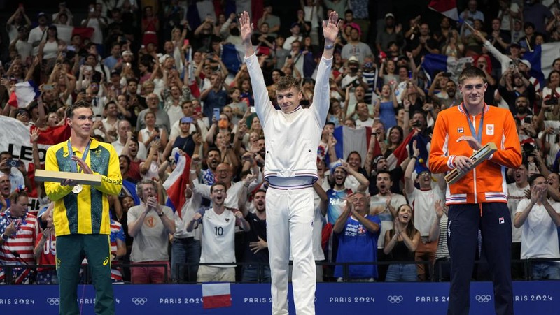 Peraih medali emas Leon Marchand bereaksi saat berdiri di podium pemenang setelah final gaya dada 200 meter putra di Olimpiade Musim Panas 2024, Rabu, 31 Juli 2024, di Nanterre, Prancis. (AP Photo/Matthias Schrader)