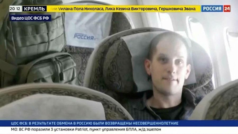 U.S. journalist Evan Gershkovich is escorted by a federal security service officer before boarding a plane during a prisoner exchange between Russia with Western countries at an undisclosed location, in this still image from August 1, 2024 broadcast video. FSB Public Relations Centre/ROSSIYA 24 TV Channel via REUTERS ATTENTION EDITORS - THIS IMAGE HAS BEEN SUPPLIED BY A THIRD PARTY. NO RESALES. NO ARCHIVES. MANDATORY CREDIT. WATERMARK AND TV GRAPHICS FROM SOURCE.