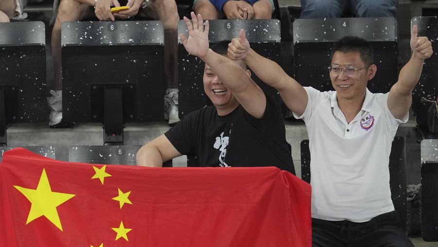 China's support wave flag during the badminton group stage match at the 2024 Summer Olympics, Saturday, July 27, 2024, in Paris, France. (AP Photo/Kin Cheung)