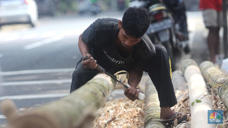 Perajin menyelesaikan pembuatan Pohon Pinang untuk Panjat dan tiang bendera bambu merah putih, di kawasan Manggarai, Jakarta, Kamis (8/8/2024). (CNBC Indonesia/Muhammad Sabki)