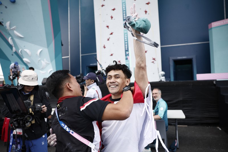 Veddriq Leonardo mengibarkan bendera Indonesia usai berhasil meraih medali emas pertama buat Indonesia usai mengalahkan Wu Peng pada final nomor speed panjat tebing di Le Boruget Climbing Venue, Kamis (8/8/2024). Veddriq Leonardo mengibarkan bendera Indonesia usai berhasil meraih medali emas pertama buat Indonesia usai mengalahkan Wu Peng pada final nomor speed panjat tebing di Le Boruget Climbing Venue, Kamis (8/8/2024). (REUTERS/Benoit Tessier)