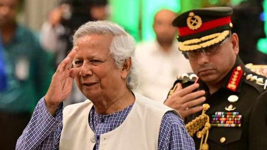 Nobel Peace Prize winner Muhammad Yunus (L) is sworn into office to lead Bangladesh's interim government as its chief adviser, days after a student-led uprising ended the 15-year rule of Sheikh Hasina, in Dhaka on August 8, 2024. (Photo by MUNIR UZ ZAMAN / AFP)