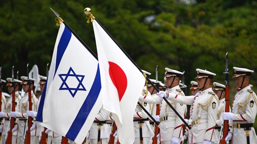 Israeli and Japanese national flags flutter in the wind as Israeli Defense Minister Benny Gantz and Japan's Defense Minister Yasukazu Hamada attend an honor guard ceremony in Tokyo Tuesday, Aug. 30, 2022. (David Mareuil/Pool Photo via AP)