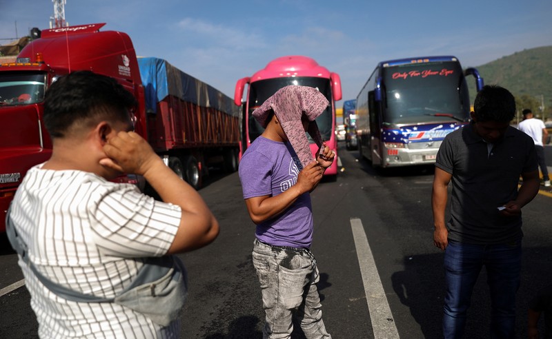 A drone view shows trailers and vehicles stranded as farmers from Santa Rita Tlahuapan block a highway to demand payment for the land expropriated for the construction of the expressway, in Tlahuapan, Puebla state, Mexico August 8, 2024. REUTERS/Diego Delgado