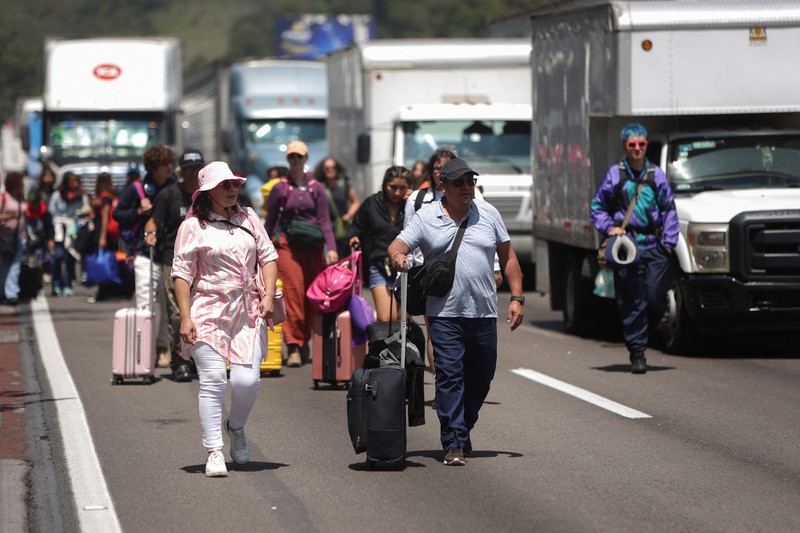 A drone view shows trailers and vehicles stranded as farmers from Santa Rita Tlahuapan block a highway to demand payment for the land expropriated for the construction of the expressway, in Tlahuapan, Puebla state, Mexico August 8, 2024. REUTERS/Diego Delgado