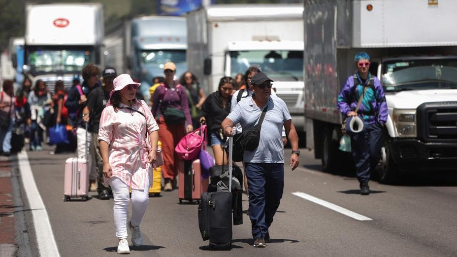 A drone view shows trailers and vehicles stranded as farmers from Santa Rita Tlahuapan block a highway to demand payment for the land expropriated for the construction of the expressway, in Tlahuapan, Puebla state, Mexico August 8, 2024. REUTERS/Diego Delgado