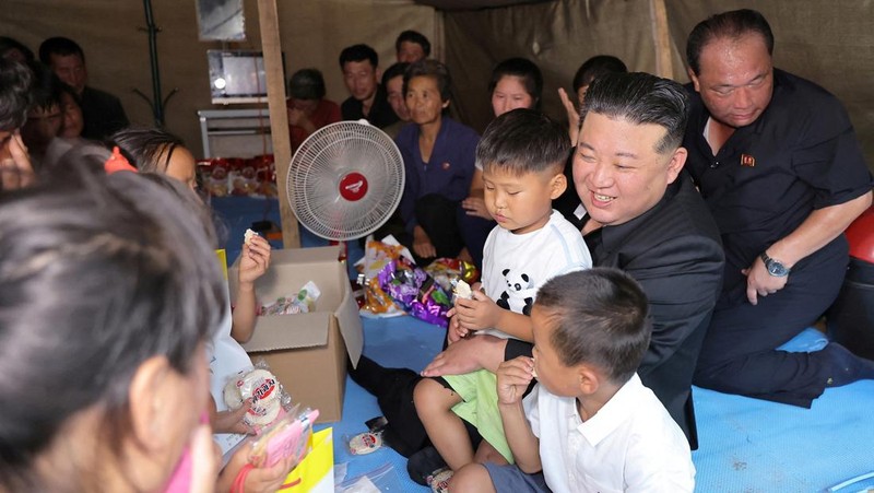 Pemimpin Korea Utara Kim Jong Un menyapa orang-orang saat berkunjung ke daerah yang terkena banjir di Kabupaten Uiju, Provinsi Pyongan Utara, Korea Utara, dalam foto yang dirilis 10 Agustus 2024. (KCNA via REUTERS)