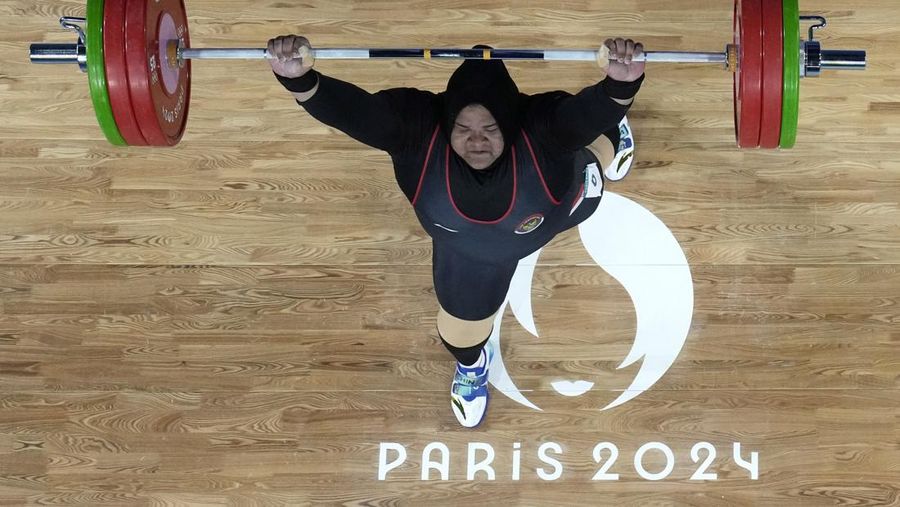 Nurul Akmal of Indonesia competes during the women's +81kg weightlifting event at the 2024 Summer Olympics, Sunday, Aug. 11, 2024, in Paris, France. (AP Photo/Dita Alangkara,Pool)