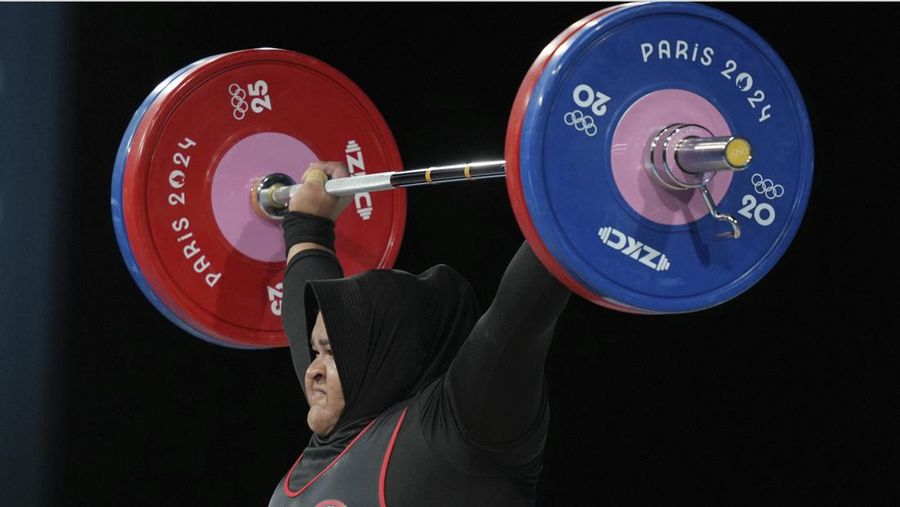 Nurul Akmal of Indonesia competes during the women's +81kg weightlifting event at the 2024 Summer Olympics, Sunday, Aug. 11, 2024, in Paris, France. (AP Photo/Dita Alangkara,Pool)