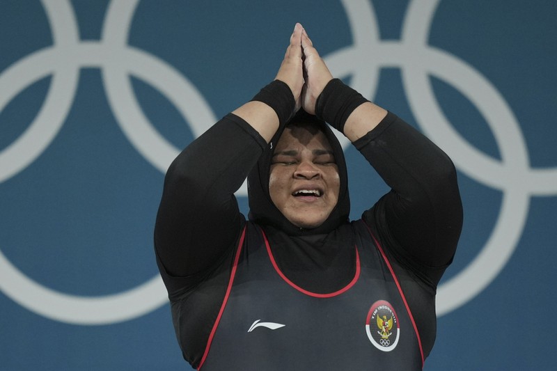 Nurul Akmal of Indonesia competes during the women's +81kg weightlifting event at the 2024 Summer Olympics, Sunday, Aug. 11, 2024, in Paris, France. (AP Photo/Dita Alangkara,Pool)