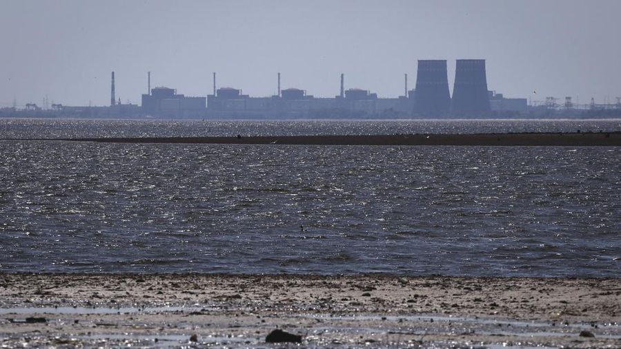 The Zaporizhzhia nuclear power plant, Europe's largest, is seen in the background of the shallow Kakhovka Reservoir after the dam collapse, in Energodar, Russian-occupied Ukraine, Friday, June 9, 2023. The plant has been under Russian occupation since 2022. (AP Photo/Kateryna Klochko)