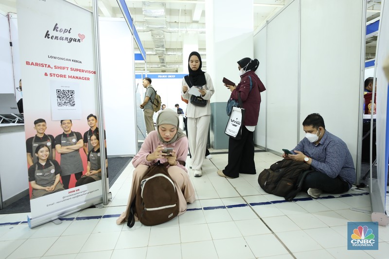 Sejumlah pencari kerja menyiapkan dokumen pribadi saat Job Fair 2024 di ITC Permata Hijau, Jakarta, Senin (13/8/2024). (CNBC Indonesia/Tri Susilo)