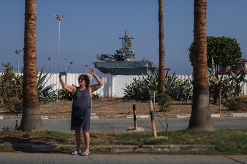Seorang pria mengambil foto kapal serbu amfibi USS Wasp (LHD-1), saat berlabuh di pelabuhan Limassol, di tengah meningkatnya ketegangan di Timur Tengah, di Limassol, Siprus, 10 Agustus 2024. Seorang pria mengambil foto kapal serbu amfibi USS Wasp (LHD-1), saat berlabuh di pelabuhan Limassol, di tengah meningkatnya ketegangan di Timur Tengah, di Limassol, Siprus, 10 Agustus 2024. (REUTERS/Stelios Misinas)