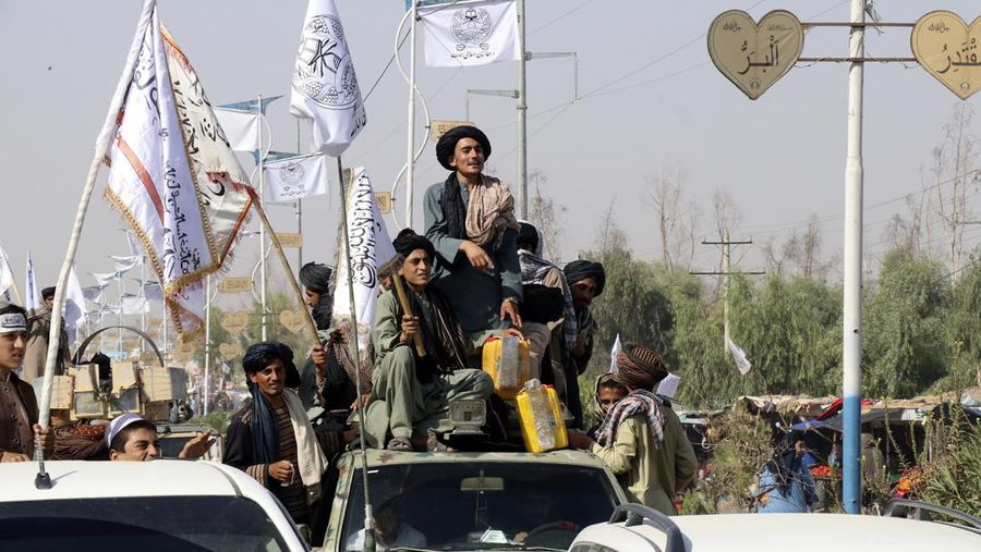 Taliban fighters celebrate the third anniversary of the withdrawal of US-led troops from Afghanistan, in Lashkar Gah, Helmand province, southwestern, Afghanistan, Wednesday, Aug. 14, 2024. (AP Photo/Abdul Khaliq)