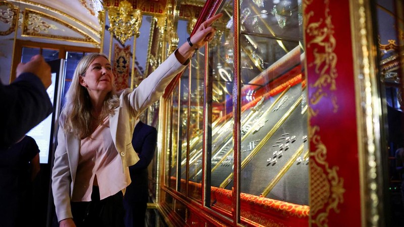 Seorang wanita mengambil gambar, saat barang-barang yang ditemukan dari pencurian permata di museum Gruenes Gewoelbe (Gudang Hijau) pada tahun 2019 dengan perkiraan nilai lebih dari 113 juta euro kembali dipamerkan setelah restorasi, di Dresden, Jerman, 13 Agustus 2024. (REUTERS/Nadja Wohlleben)