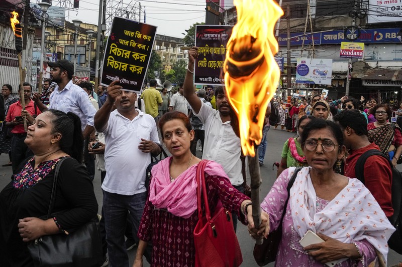Para dokter muda memprotes pemerkosaan dan pembunuhan seorang petugas medis di Kolkata minggu lalu, dalam acara peringatan dengan menyalakan lilin di Hyderabad, India, Senin, 12 Agustus 2024. (AP Photo/Mahesh Kumar A.)