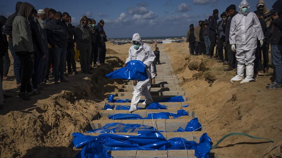Israel Palestinians Death Toll FILE - Palestinians bury the bodies of people who were killed in fighting with Israel and returned to Gaza by the Israeli military, during a mass funeral in Rafah, Gaza Strip, Tuesday, Jan. 30, 2024. (AP Photo/Fatima Shbair, File)