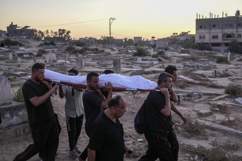 Israel Palestinians Death Without Dignity Palestinian mourners carry their loved one for burial at the cemetery in Deir al-Balah, Gaza Strip, Friday, Aug. 9, 2024. (AP Photo/Abdel Kareem Hana)