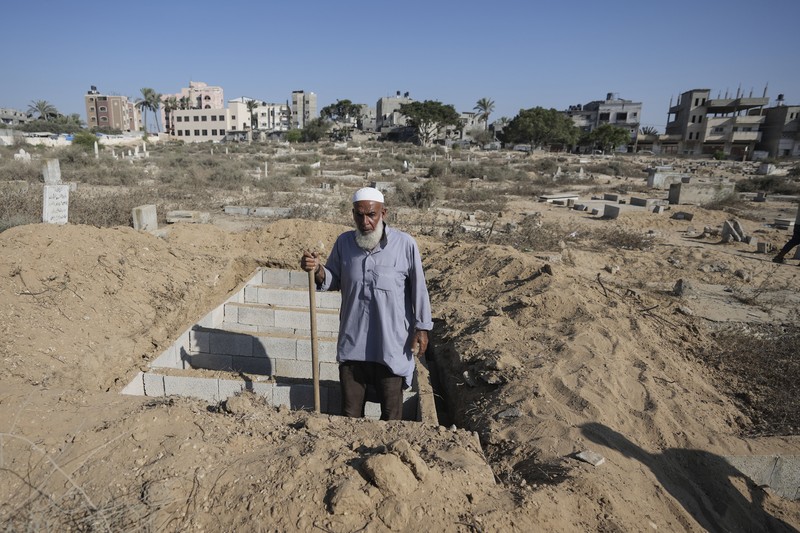 Israel Palestinians Death Without Dignity Palestinian mourners carry their loved one for burial at the cemetery in Deir al-Balah, Gaza Strip, Friday, Aug. 9, 2024. (AP Photo/Abdel Kareem Hana)