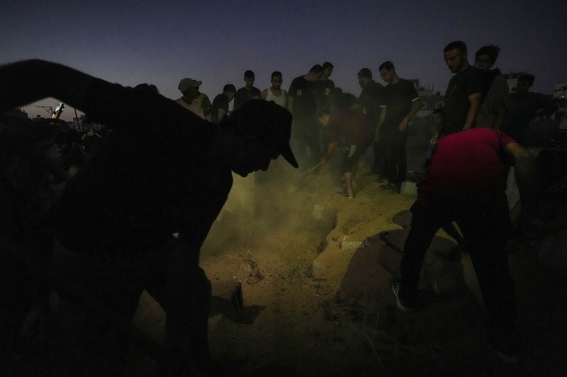 Israel Palestinians Death Without Dignity Palestinian mourners carry their loved one for burial at the cemetery in Deir al-Balah, Gaza Strip, Friday, Aug. 9, 2024. (AP Photo/Abdel Kareem Hana)