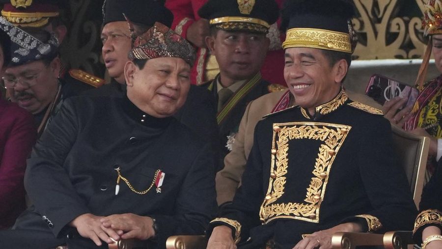 Indonesian President Joko Widodo, right, confers with Defense Minister and president-elect Prabowo Subianto during the ceremony marking Indonesia's 79th anniversary of independence at the new presidential palace in its future capital of Nusantara, a city still under construction on the island of Borneo, Saturday, Aug. 17, 2024. (AP Photo/Achmad Ibrahim)