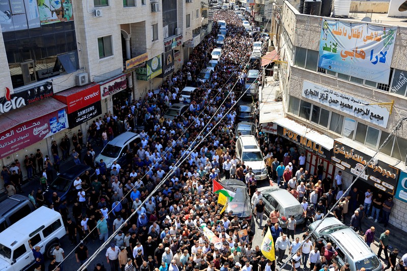 Para pelayat membawa jenazah seorang warga Palestina berusia 18 tahun saat prosesi pemakaman di Dura, Tepi Barat, Selasa (20/8/2024). (REUTERS/Mussa Qawasma) Para pelayat membawa jenazah seorang warga Palestina berusia 18 tahun saat prosesi pemakaman di Dura, Tepi Barat, Selasa (20/8/2024). (REUTERS/Mussa Qawasma)