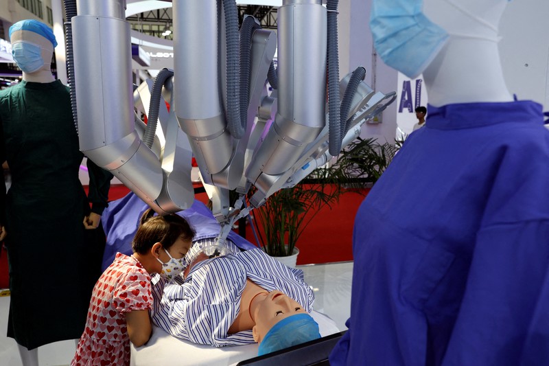 Seorang pekerja berjalan melewati berbagai jenis robot mirip manusia di Konferensi Robot Dunia yang diadakan di Beijing, Rabu, 21 Agustus 2024. Seorang pekerja berjalan melewati berbagai jenis robot mirip manusia di Konferensi Robot Dunia yang diadakan di Beijing, Rabu, 21 Agustus 2024. (AP Photo/Ng Han Guan)