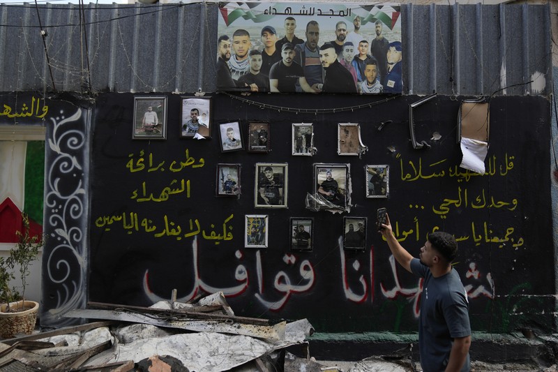 Palestinians stand outside a heavily damaged mosque following an Israeli military operation in the West Bank refugee camp of Al-Faraa, Thursday, Aug. 29, 2024. (AP Photo/Nasser Nasser)