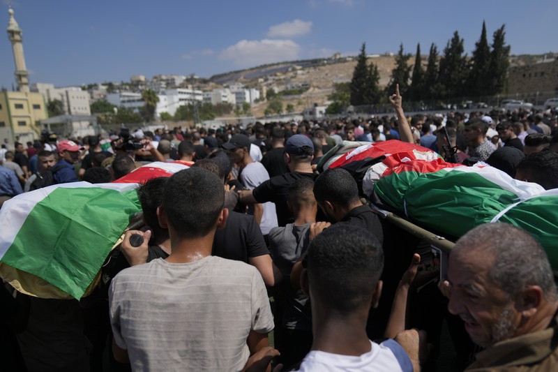 Palestinians stand outside a heavily damaged mosque following an Israeli military operation in the West Bank refugee camp of Al-Faraa, Thursday, Aug. 29, 2024. (AP Photo/Nasser Nasser)