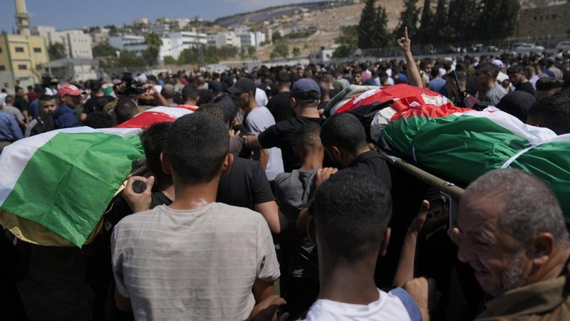 Palestinians stand outside a heavily damaged mosque following an Israeli military operation in the West Bank refugee camp of Al-Faraa, Thursday, Aug. 29, 2024. (AP Photo/Nasser Nasser)