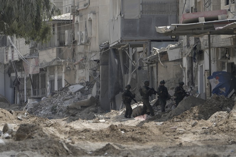 Palestinians stand outside a heavily damaged mosque following an Israeli military operation in the West Bank refugee camp of Al-Faraa, Thursday, Aug. 29, 2024. (AP Photo/Nasser Nasser)