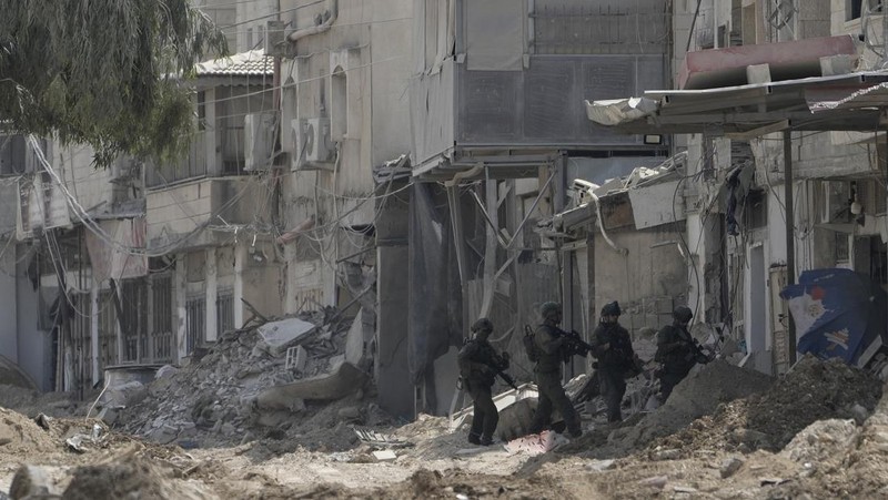 Palestinians stand outside a heavily damaged mosque following an Israeli military operation in the West Bank refugee camp of Al-Faraa, Thursday, Aug. 29, 2024. (AP Photo/Nasser Nasser)
