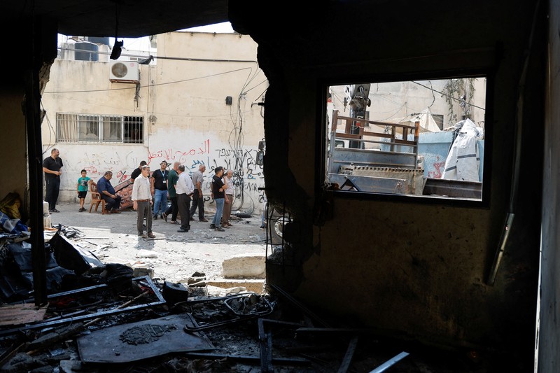 Palestinians stand outside a heavily damaged mosque following an Israeli military operation in the West Bank refugee camp of Al-Faraa, Thursday, Aug. 29, 2024. (AP Photo/Nasser Nasser)