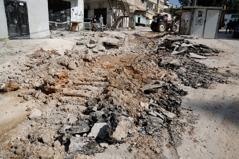 Palestinians stand outside a heavily damaged mosque following an Israeli military operation in the West Bank refugee camp of Al-Faraa, Thursday, Aug. 29, 2024. (AP Photo/Nasser Nasser)