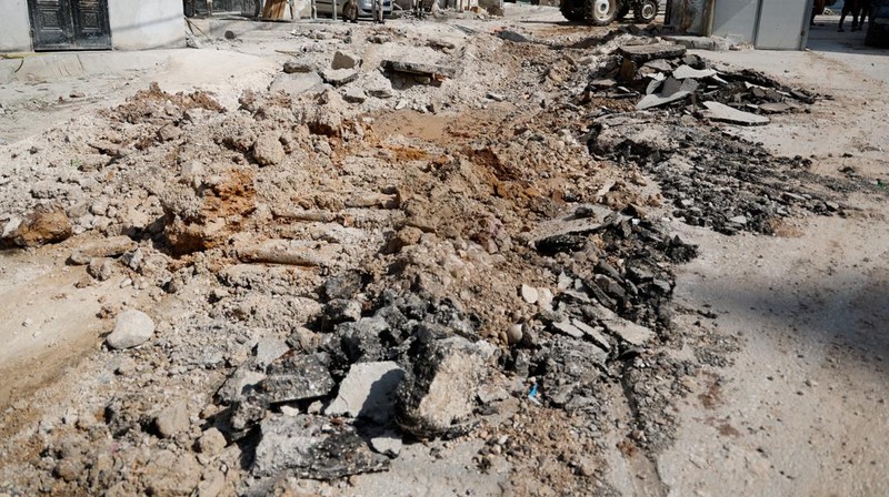 Palestinians stand outside a heavily damaged mosque following an Israeli military operation in the West Bank refugee camp of Al-Faraa, Thursday, Aug. 29, 2024. (AP Photo/Nasser Nasser)
