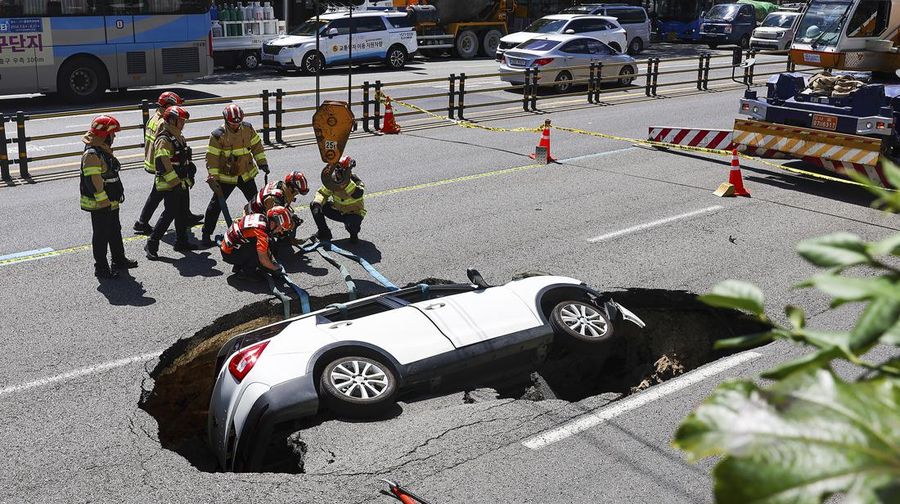 A vehicle that fell into a sinkhole is seen on a street in Seoul, South Korea, Thursday, Aug. 29, 2024. (Seo Dae-yeon/Yonhap via AP)