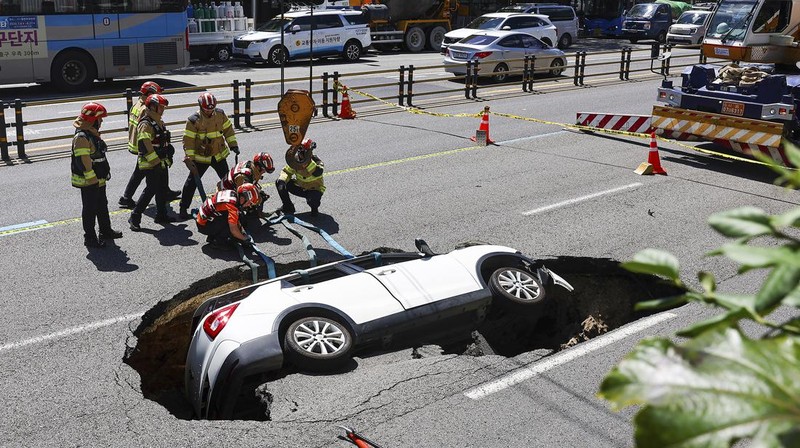 A vehicle that fell into a sinkhole is seen on a street in Seoul, South Korea, Thursday, Aug. 29, 2024. (Seo Dae-yeon/Yonhap via AP)