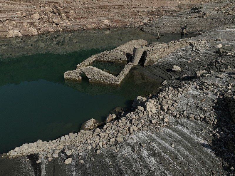 The reappearing remains of buildings of the village of Kallio, which was intentionally flooded in 1980 to create a reservoir that would help meet the water needs of Greek capital Athens, are seen following receding water levels caused by drought, in Lake Mornos, Greece, September 3, 2024. REUTERS/Stelios Misinas