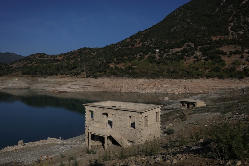 The reappearing remains of buildings of the village of Kallio, which was intentionally flooded in 1980 to create a reservoir that would help meet the water needs of Greek capital Athens, are seen following receding water levels caused by drought, in Lake Mornos, Greece, September 3, 2024. REUTERS/Stelios Misinas
