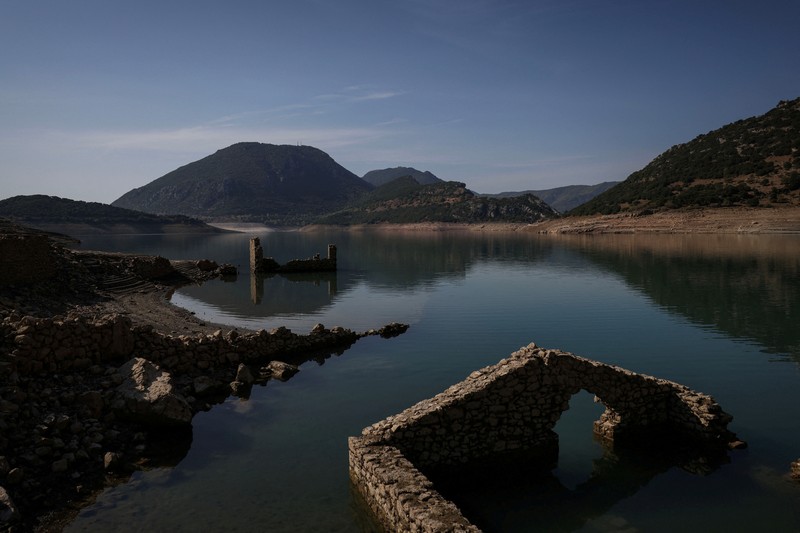 The reappearing remains of buildings of the village of Kallio, which was intentionally flooded in 1980 to create a reservoir that would help meet the water needs of Greek capital Athens, are seen following receding water levels caused by drought, in Lake Mornos, Greece, September 3, 2024. REUTERS/Stelios Misinas