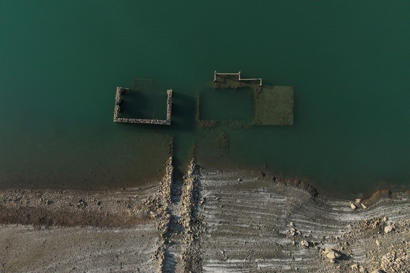The reappearing remains of buildings of the village of Kallio, which was intentionally flooded in 1980 to create a reservoir that would help meet the water needs of Greek capital Athens, are seen following receding water levels caused by drought, in Lake Mornos, Greece, September 3, 2024. REUTERS/Stelios Misinas