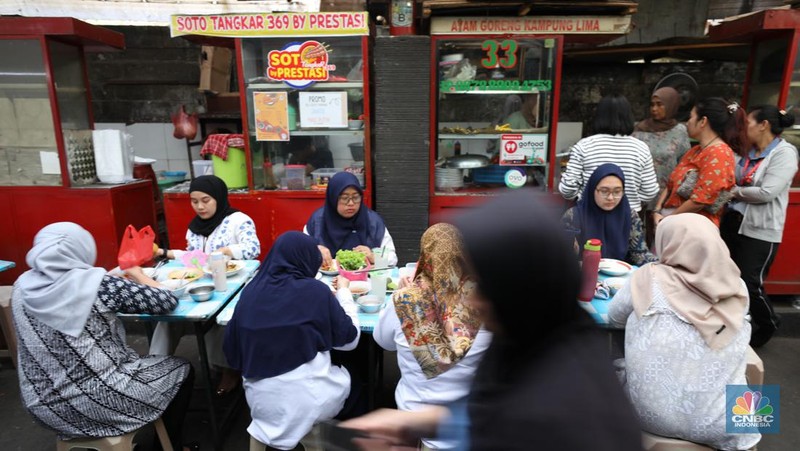 Sejumlah pekerja menyantap makan siang di pusat kuliner di kawasan Jakarta, Jumat (6/9/2024). (CNBC Indonesia/Tri Susilo)