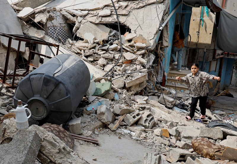 A Palestinian child walks along a damaged road, following a several day long Israeli-raid, in Jenin camp, in the Israeli-occupied West Bank, September 6, 2024. REUTERS/Raneen Sawafta