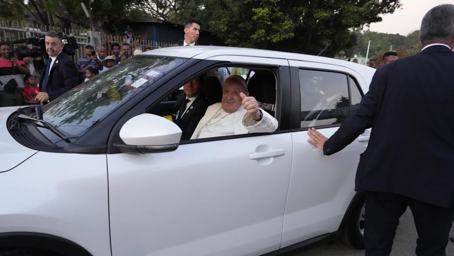 Pope Francis rides in a car after landing at Port Moresby Jackson International Airport, in Port Moresby, Papua New Guinea, September 6, 2024. REUTERS/Guglielmo Mangiapane
