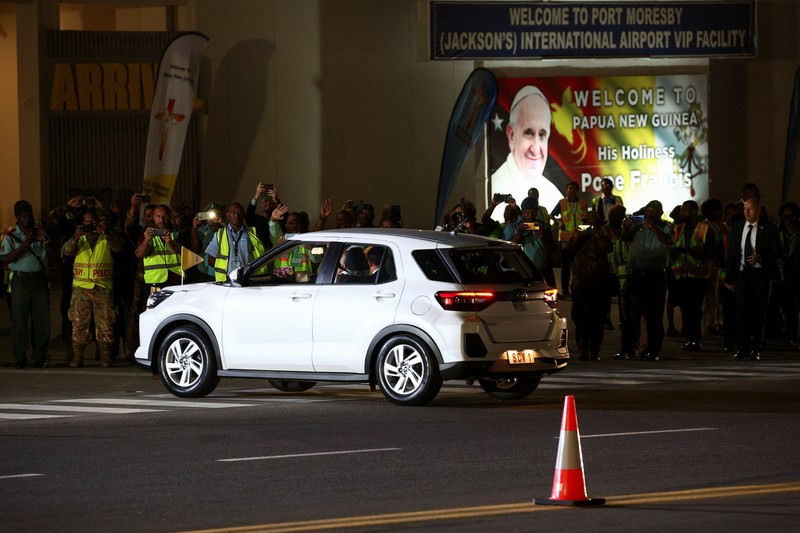 Pope Francis rides in a car after landing at Port Moresby Jackson International Airport, in Port Moresby, Papua New Guinea, September 6, 2024. REUTERS/Guglielmo Mangiapane