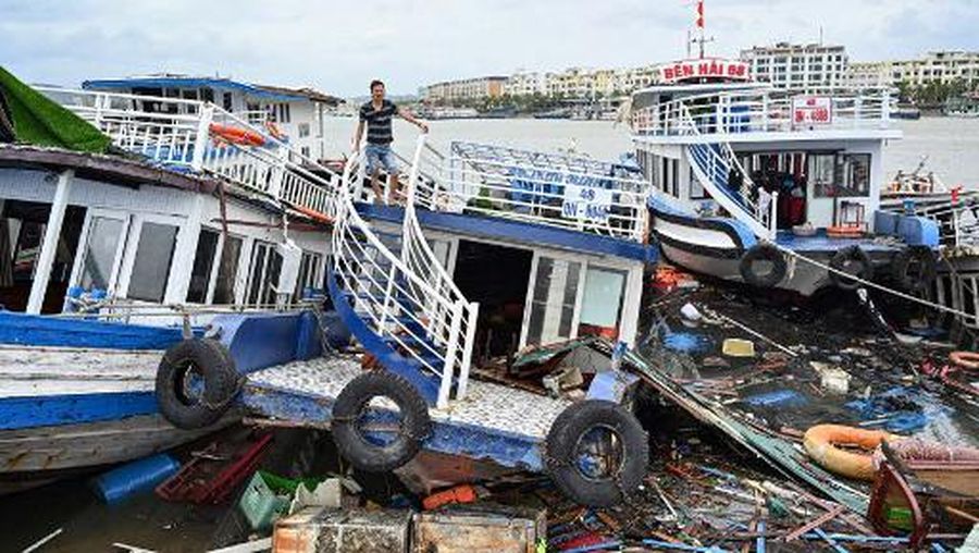 This aerial picture shows damaged buildings and debris on a street after Super Typhoon Yagi hit Ha Long, in Quang Ninh province, on September 8, 2024. Super Typhoon Yagi uproots thousands of trees, sweeps ships and boats out to sea and rips roofs off houses in northern Vietnam, after leaving a trail of destruction in southern China and the Philippines. (Photo by NHAC NGUYEN / AFP)