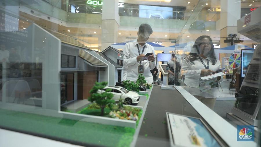 Warga mengamati miniatur rumah yang ada di kawasan Jakarta, Senin (9/9/2024). Bank Indonesia (BI) melaporkan hasil survei Harga Properti Residensial (SHPR), yang mengindikasikan bahwa harga properti residensial di pasar primer meningkat terbatas pada kuartal II-2024. (CNBC Indonesia/Tri Susilo)