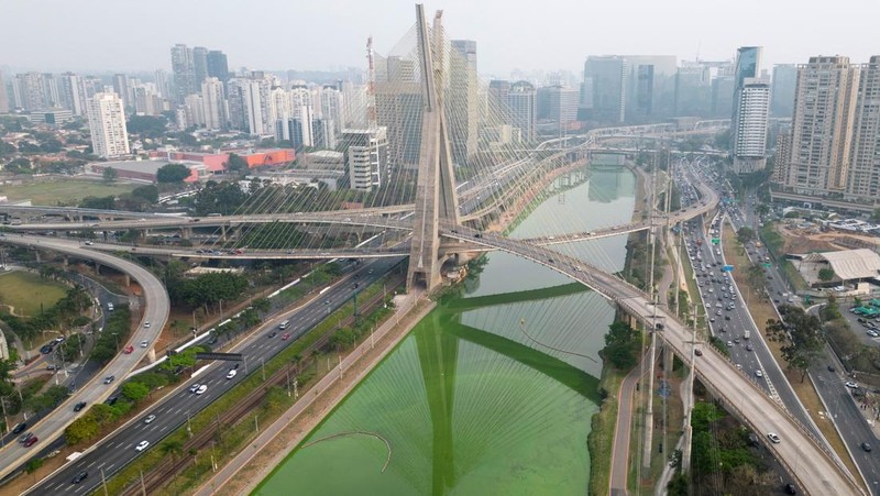 Pemandangan drone menunjukkan perkembangbiakan alga yang mengubah Sungai Pinheiros menjadi hijau setelah cuaca kering dan kurangnya hujan mengurangi kontribusi anak sungai, meningkatkan konsentrasi nutrisi dan mendukung pertumbuhan alga, di Sao Paulo, Brasil 10 September 2024. (REUTERS/Jorge Silva)