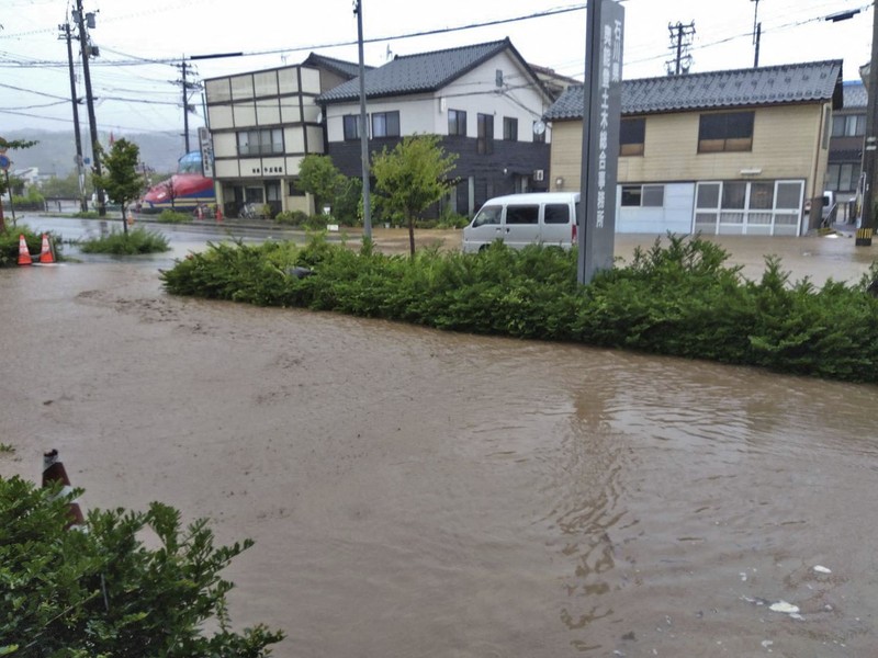 Foto udara menujukkan kendaraan dan rumah yang terendam akibat hujan deras di kota Wajima, Prefektur Ishikawa, Jepang, Minggu (21/9/2024). (via REUTERS/KYODO)