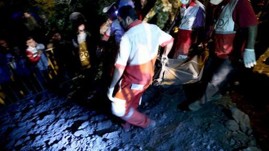 Rescue workers carry the body of a coal miner after he was pulled out from a mine in Azadshahr, in northern Iran, following an explosion leaving dozens of miners trapped on May 4, 2017. Rescuers battled hazardous conditions at the coal mine in northern Iran where 21 miners died in a failed attempt to save workmates trapped deep underground after an explosion. (Photo by MOSTAFA HASSANZADEH / TASNIM NEWS / AFP)
